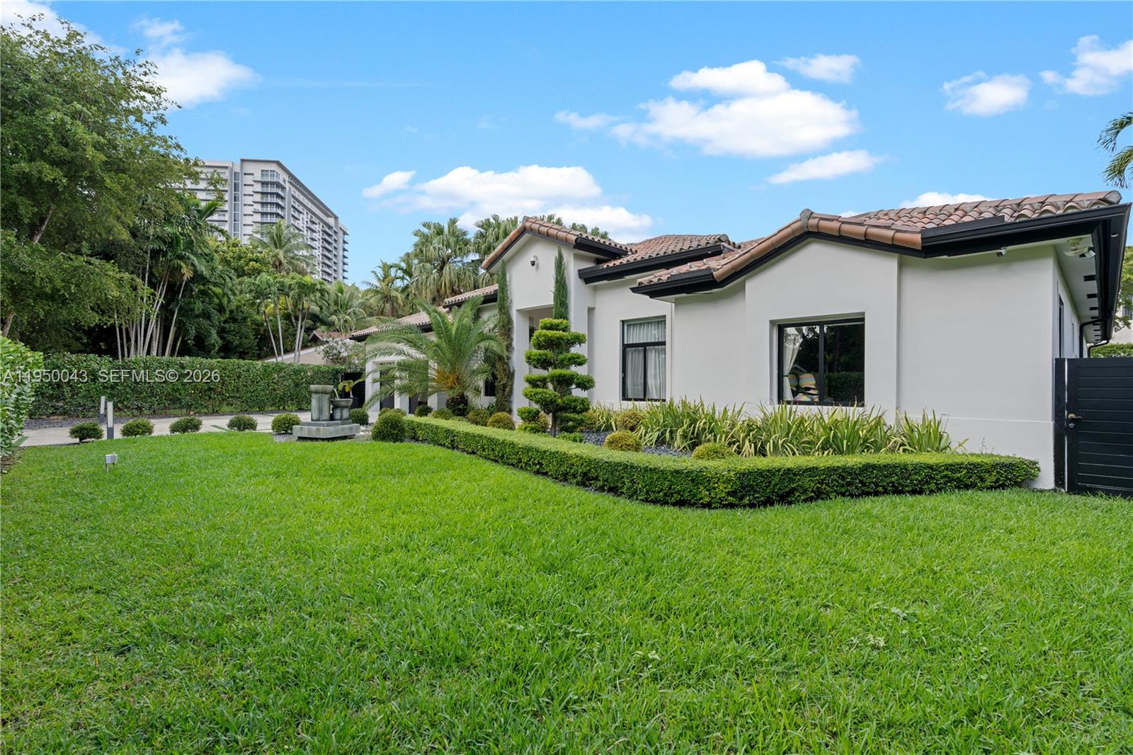 7345 Southwest 96th Street Pinecrest, FL 33156 - Photo 4 of 62 a view of a house with a backyard and a garden