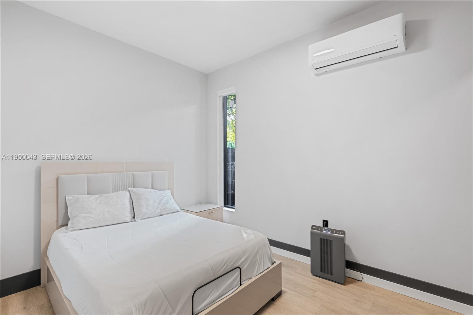 7345 Southwest 96th Street Pinecrest, FL 33156 - Photo 43 of 62 a bedroom with a bed and a window