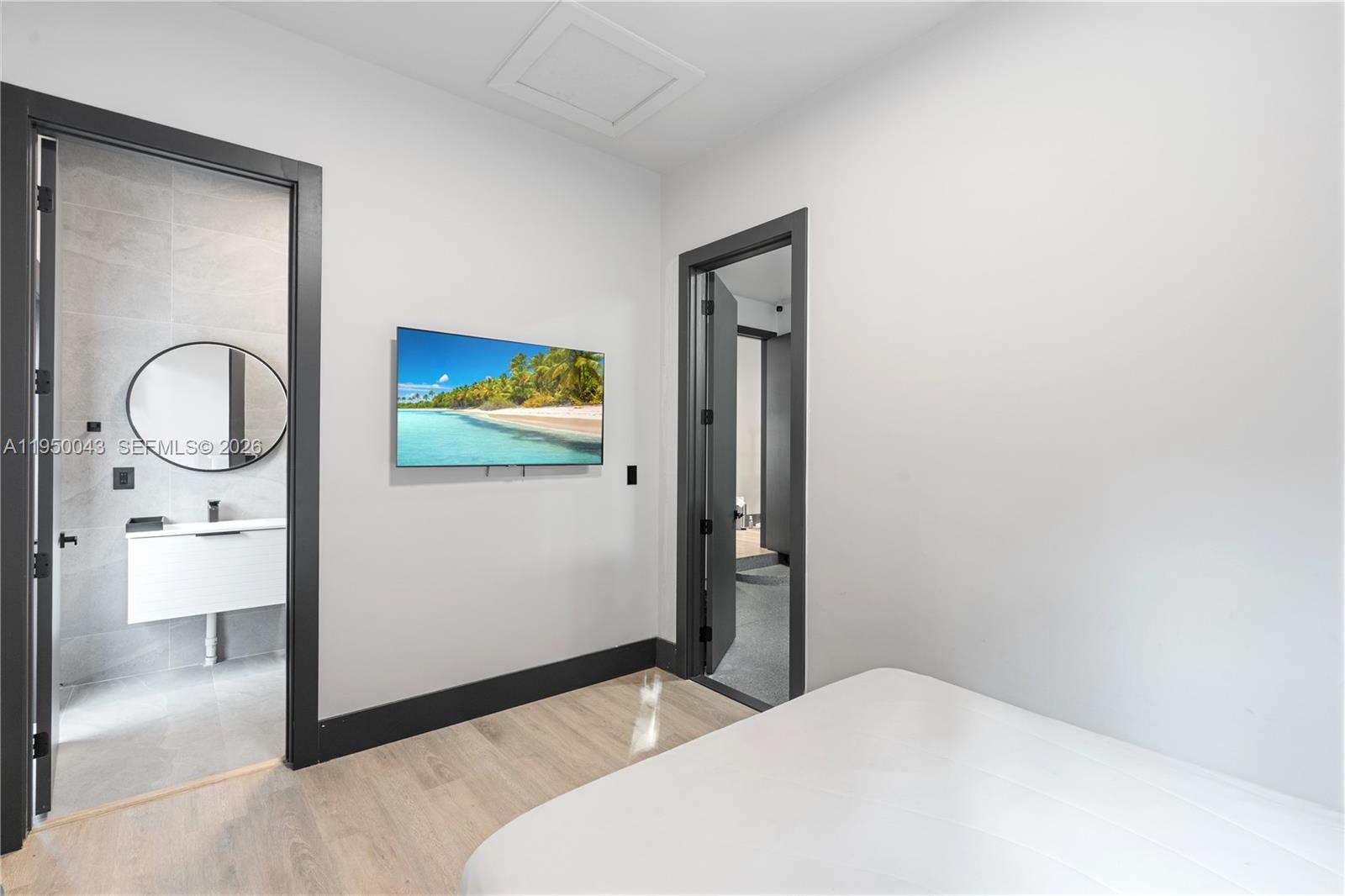 7345 Southwest 96th Street Pinecrest, FL 33156 - Photo 44 of 62 a bedroom with a bed and a mirror