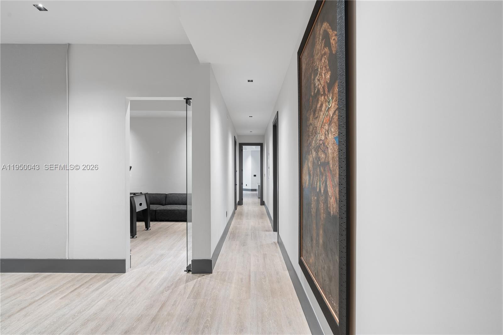 7345 Southwest 96th Street Pinecrest, FL 33156 - Photo 45 of 60 a view of a hallway with wooden floor and a bathroom
