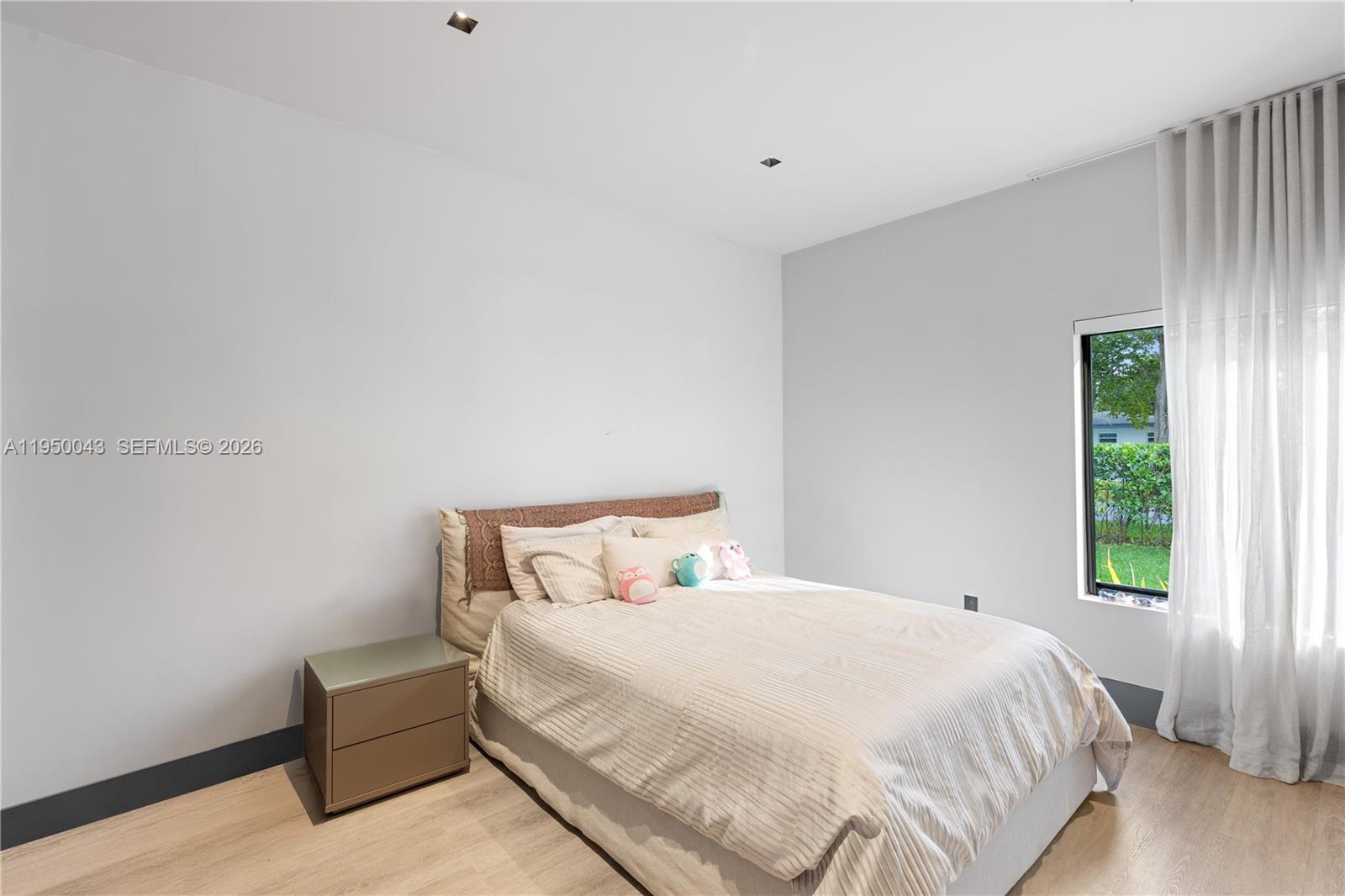 7345 Southwest 96th Street Pinecrest, FL 33156 - Photo 51 of 62 a bedroom with a bed and a window