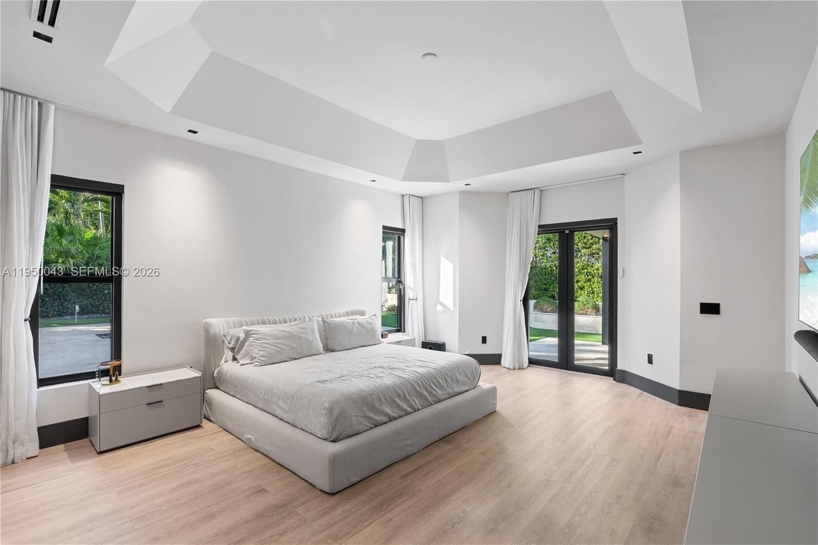 7345 Southwest 96th Street Pinecrest, FL 33156 - Photo 52 of 60 a bedroom with a large bed and a large window