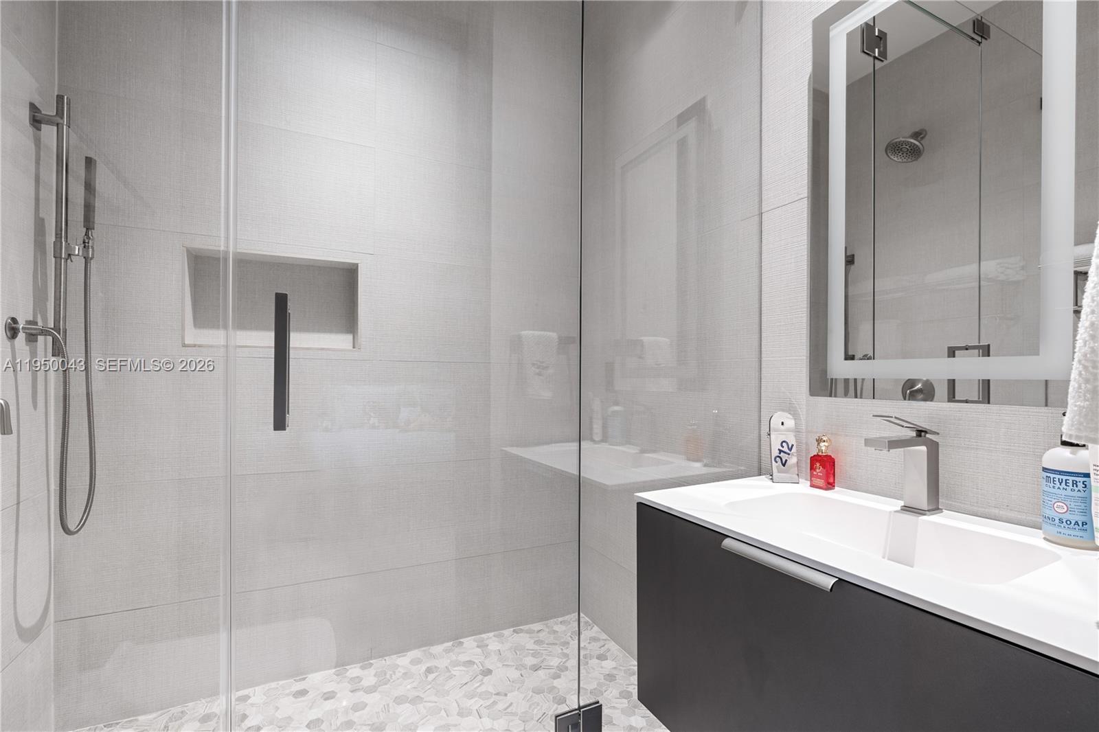 7345 Southwest 96th Street Pinecrest, FL 33156 - Photo 53 of 62 a bathroom with a sink vanity granite tub shower and a mirror