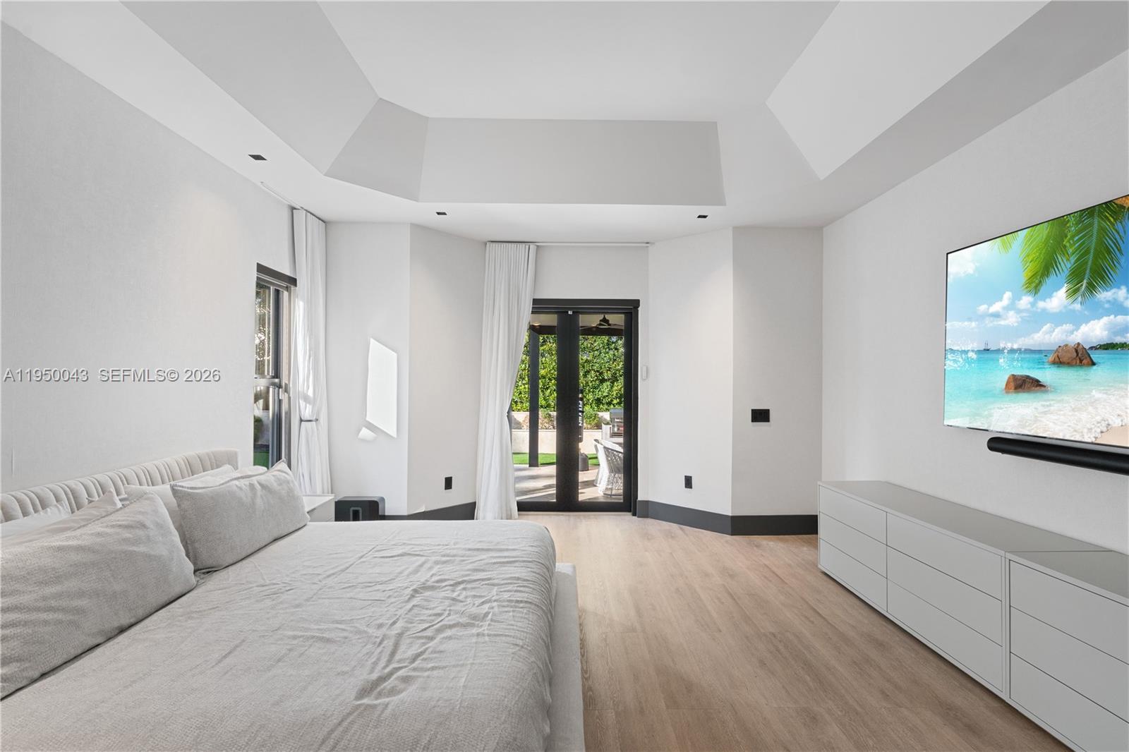 7345 Southwest 96th Street Pinecrest, FL 33156 - Photo 53 of 60 a spacious bedroom with a large bed and a window