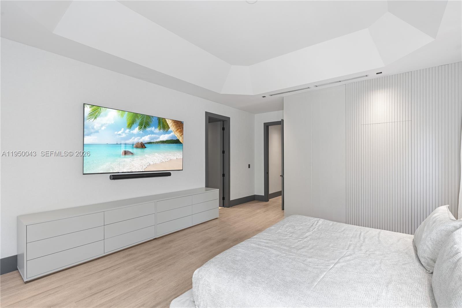 7345 Southwest 96th Street Pinecrest, FL 33156 - Photo 54 of 60 a bedroom with a bed and a flat screen tv