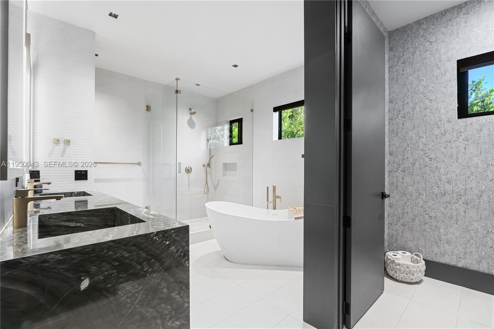 7345 Southwest 96th Street Pinecrest, FL 33156 - Photo 57 of 60 a bathroom with a sink a toilet and a bathtub