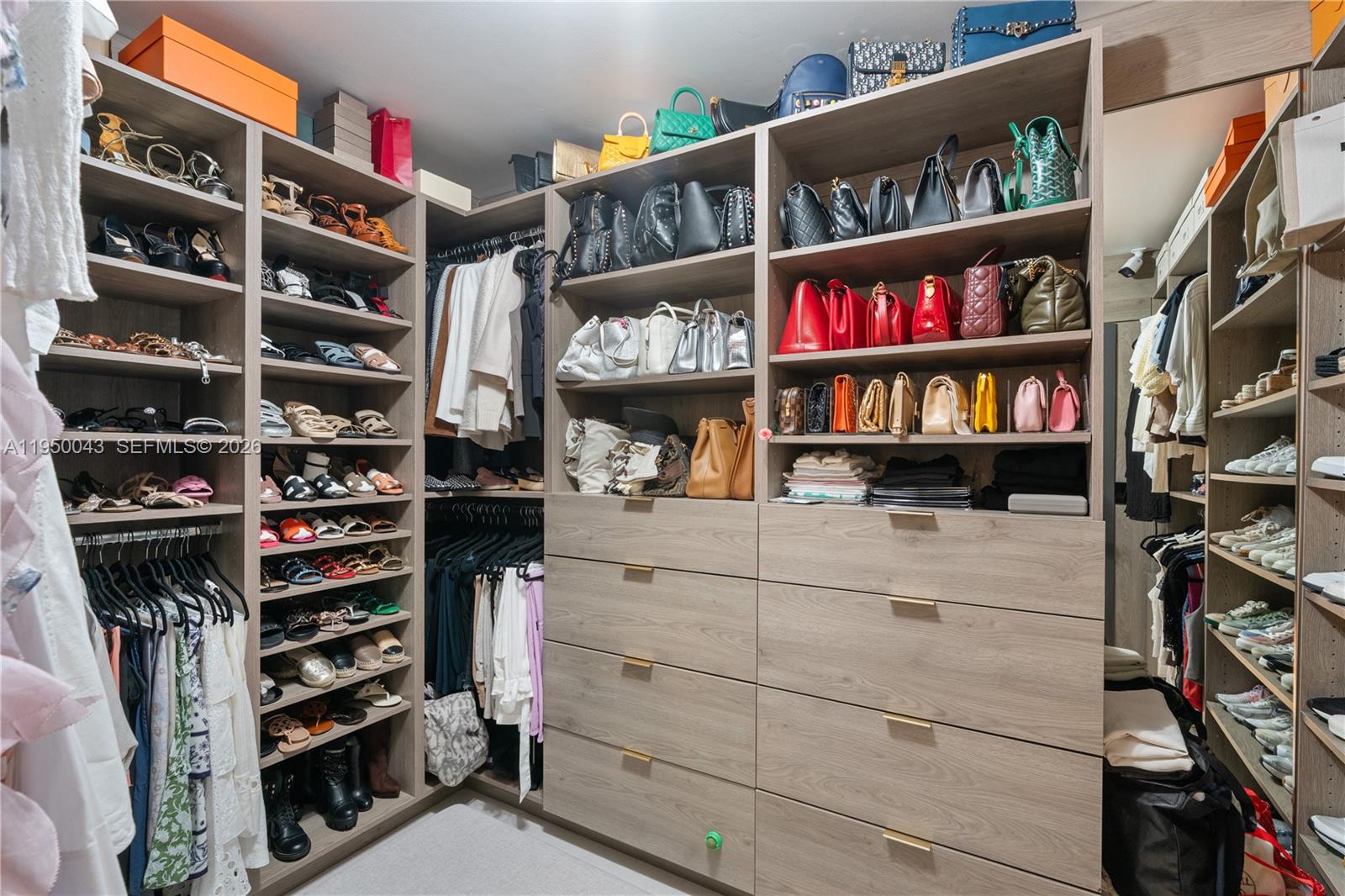7345 Southwest 96th Street Pinecrest, FL 33156 - Photo 60 of 60 a view of walk in closet with clothes and shoes