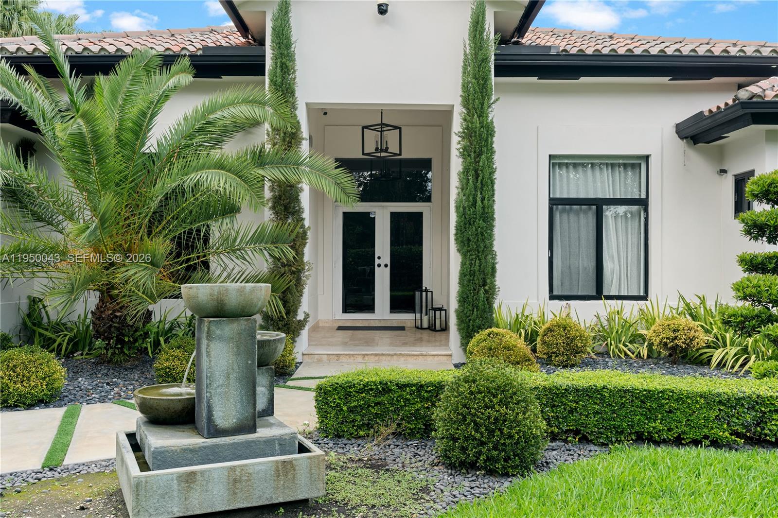 7345 Southwest 96th Street Pinecrest, FL 33156 - Photo 6 of 62 a front view of a house with plants