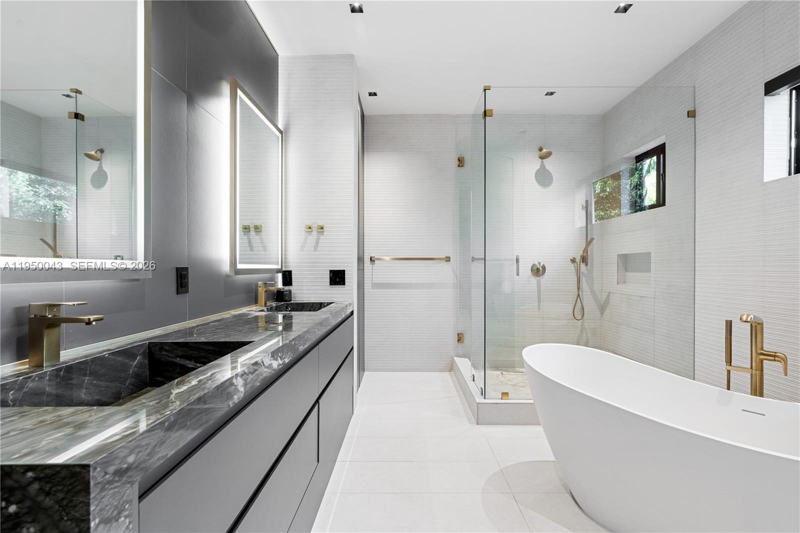 7345 Southwest 96th Street Pinecrest, FL 33156 - Photo 61 of 62 a spacious bathroom with a granite countertop tub sink and mirror