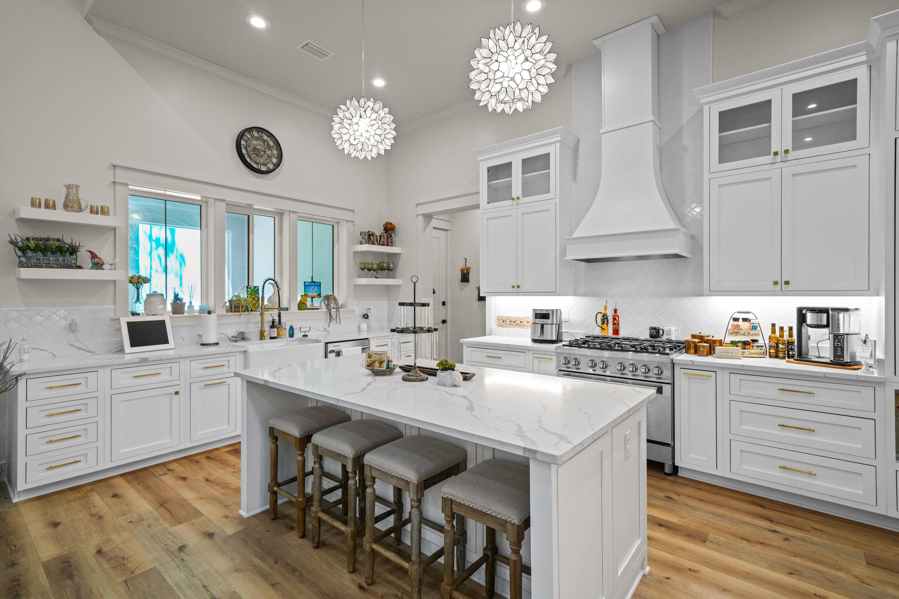 279 Smith Drive Santa Rosa Beach, FL 32459 - Photo 13 of 56 a kitchen with a stove a sink a dining table and chairs