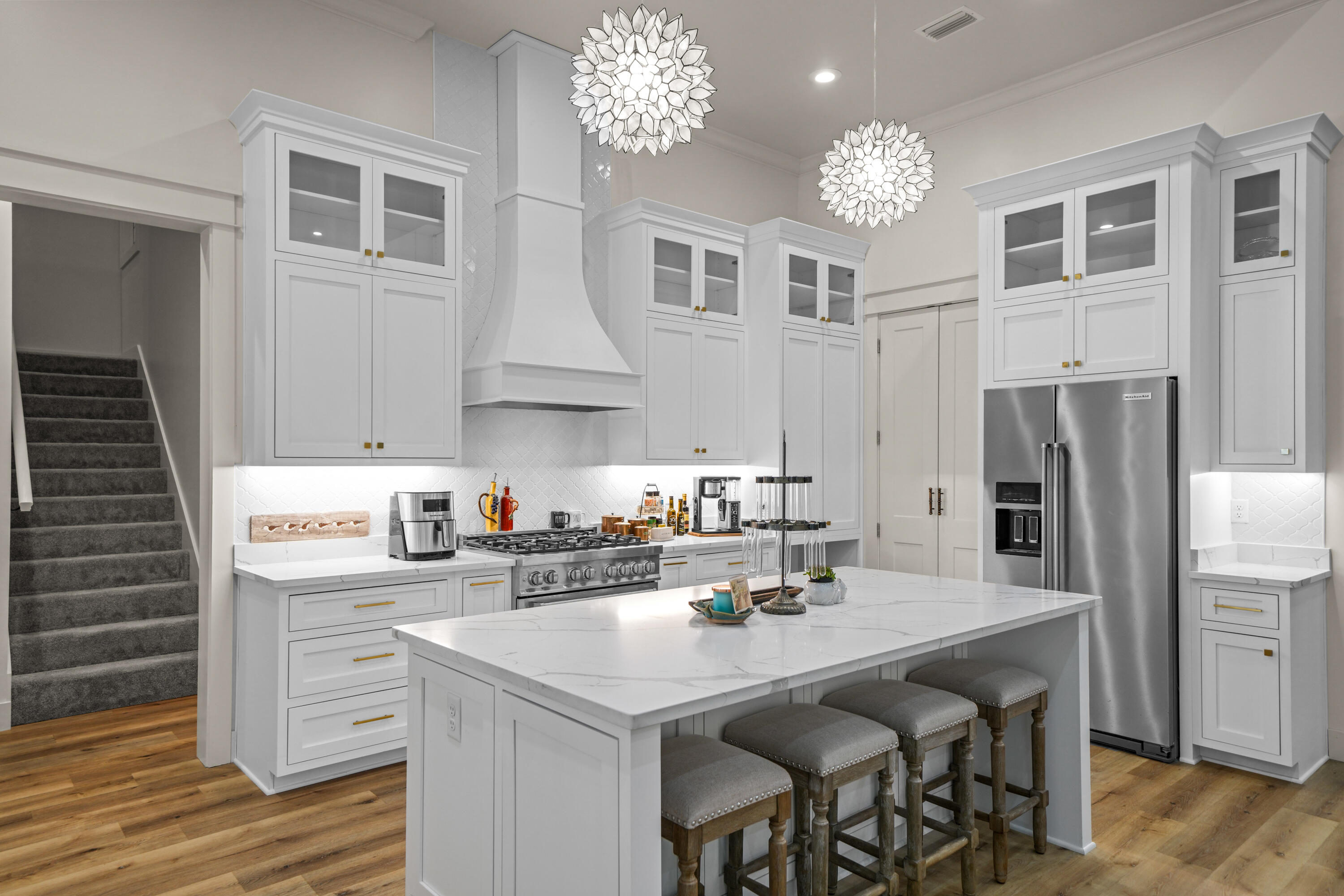 279 Smith Drive Santa Rosa Beach, FL 32459 - Photo 14 of 56 a kitchen with a sink stainless steel appliances and chandelier