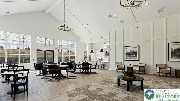 a kitchen with stainless steel appliances kitchen island granite countertop a table and chairs in it