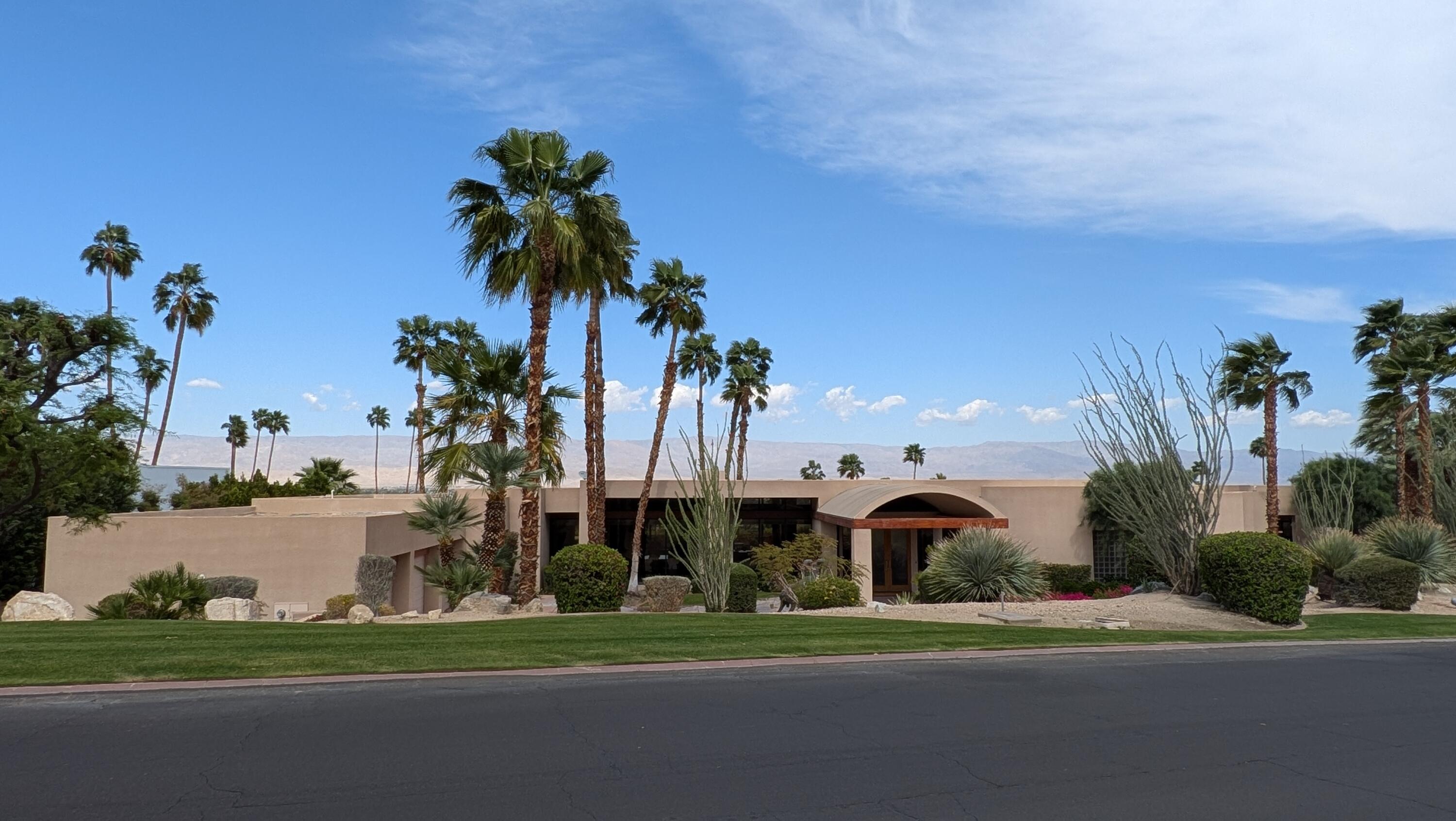 70250 Thunderbird Road Rancho Mirage, CA 92270 - Photo 1 of 2 a front view of a house with a yard and palm trees