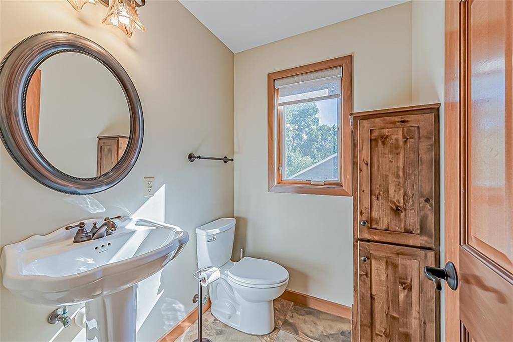 3057 County Line Road New Castle, PA 16101 - Photo 14 of 24 a bathroom with a toilet a sink and a mirror