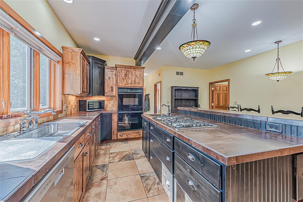 3057 County Line Road New Castle, PA 16101 - Photo 8 of 24 a kitchen with a stove kitchen island and a refrigerator