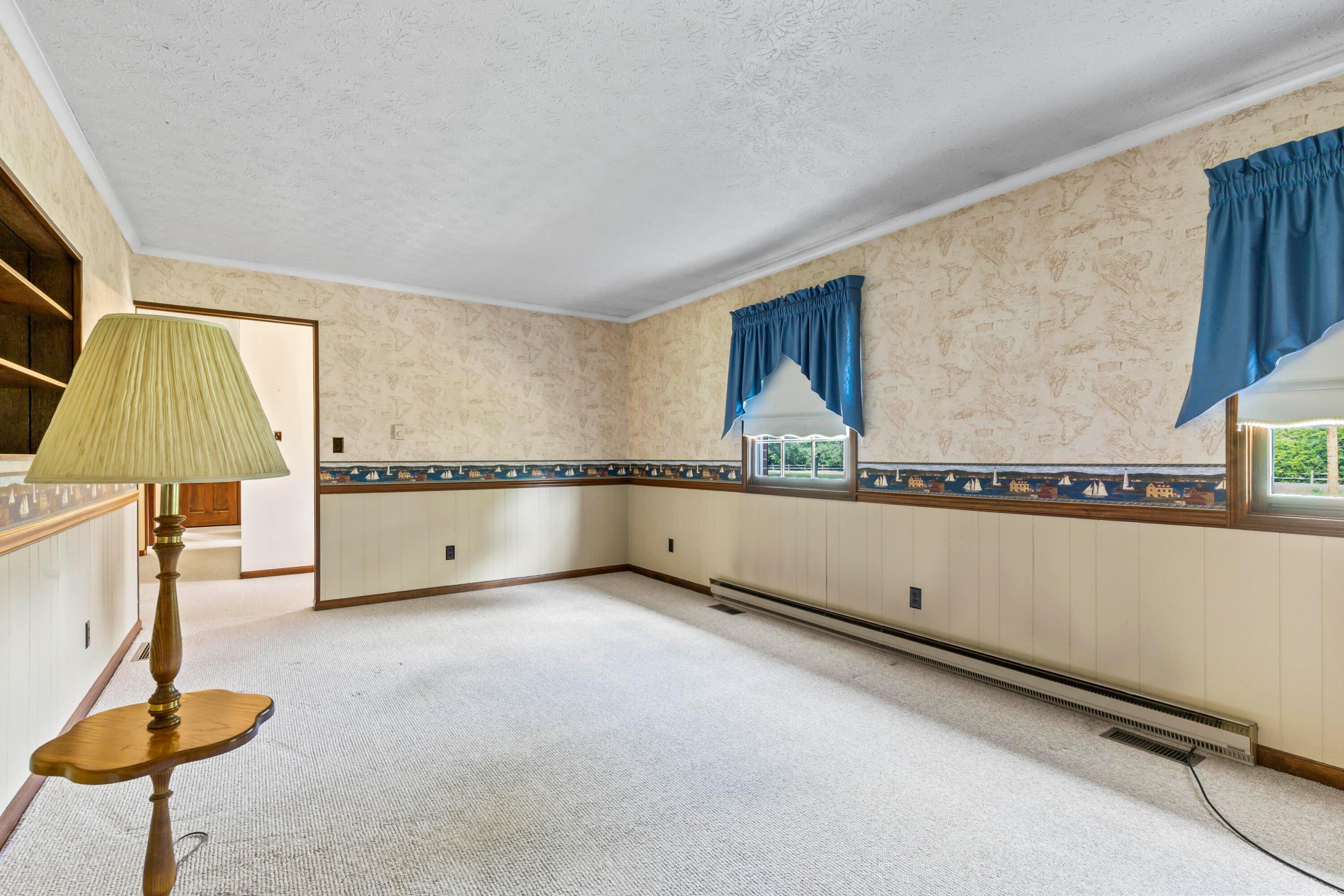 5764 Cheshire Road Galena, OH 43021 - Photo 6 of 59 • Berber carpet
• Papered & panelled walls
• Chair railing
• Crown molding
• Brick fireplace with mantle
& raised hearth