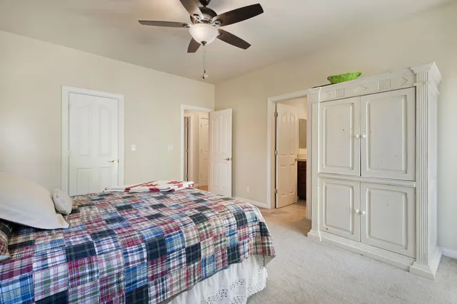 a spacious bedroom with a bed and a chandelier