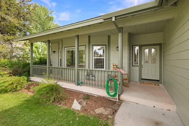 a view of a chair and table in the back yard