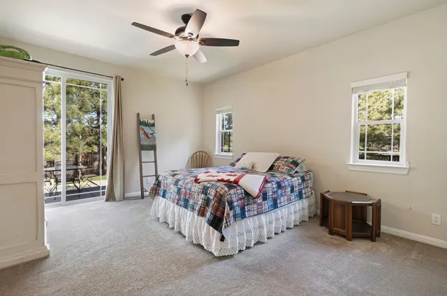 a bedroom with a bed and a lamp next to a window