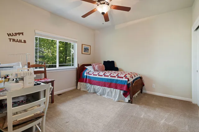 a bedroom with a bed and a desk