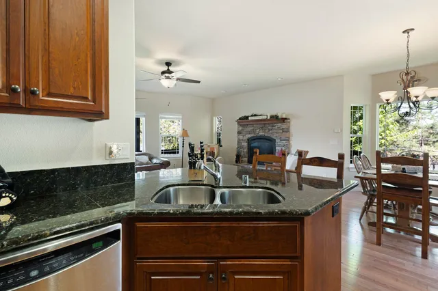 a kitchen with stainless steel appliances granite countertop a sink and a granite counter tops