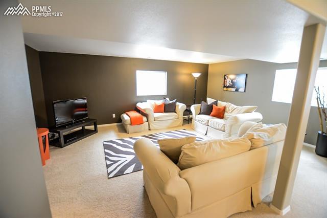 12340 Motley Road Peyton, CO 80831 - Photo 11 of 32 Come Chill in the basement family room.