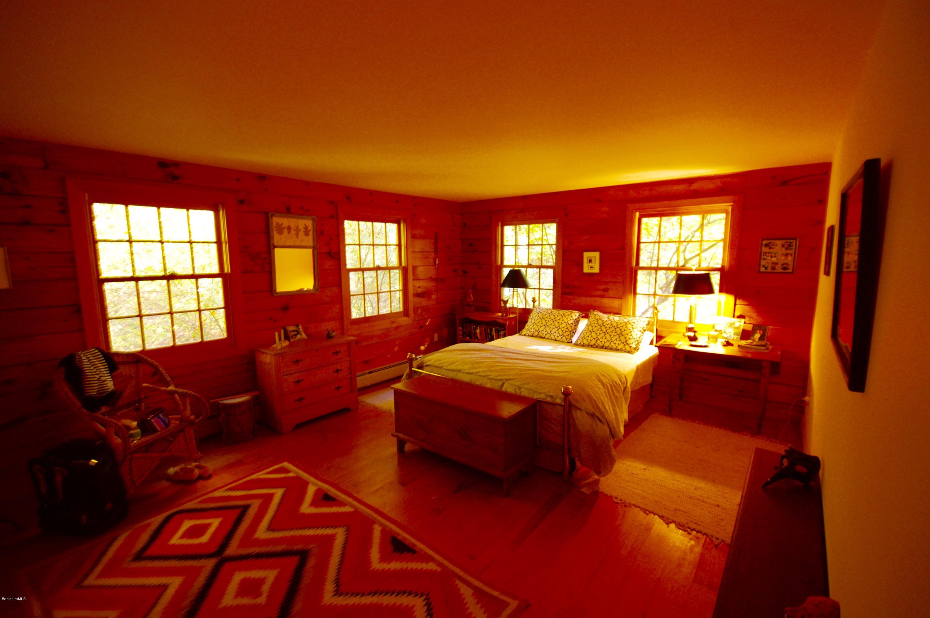 157 Chipman Road Middlefield, MA 01011 - Photo 4 of 11 a bedroom with furniture and large windows
