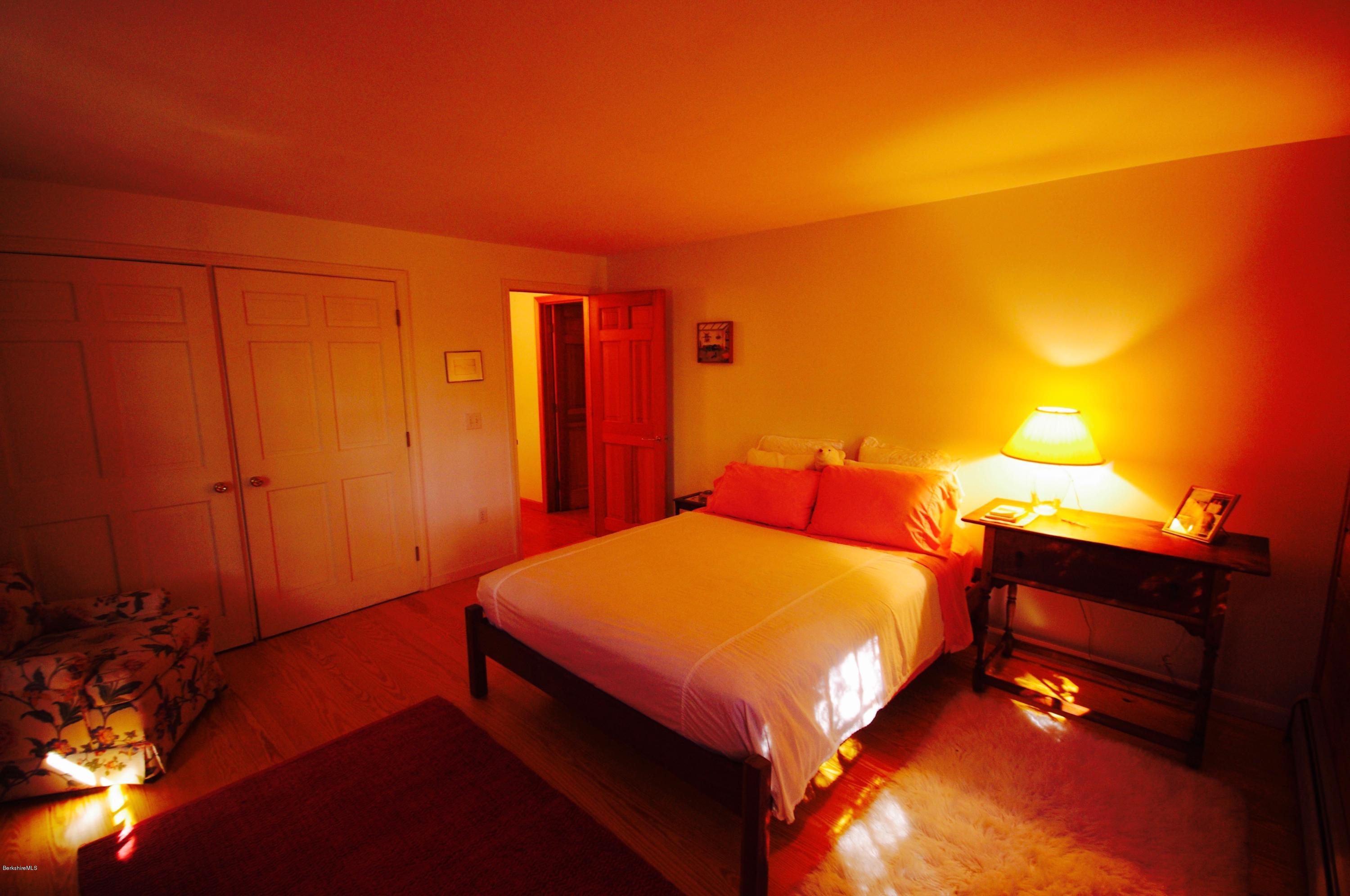 157 Chipman Road Middlefield, MA 01011 - Photo 5 of 11 a bedroom with a bed and a lamp with the lamp