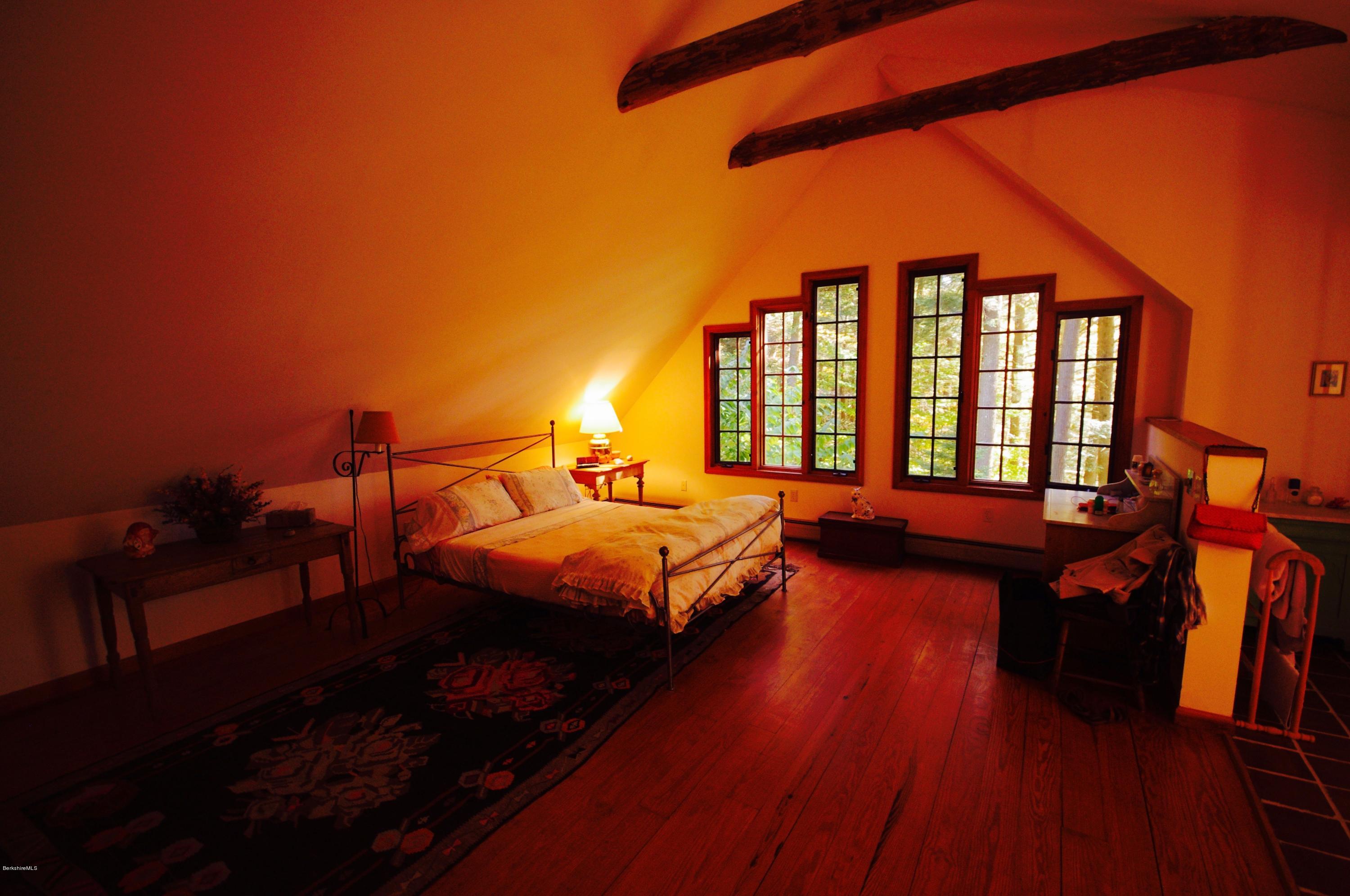 157 Chipman Road Middlefield, MA 01011 - Photo 8 of 11 a bedroom with a bed and wooden floor