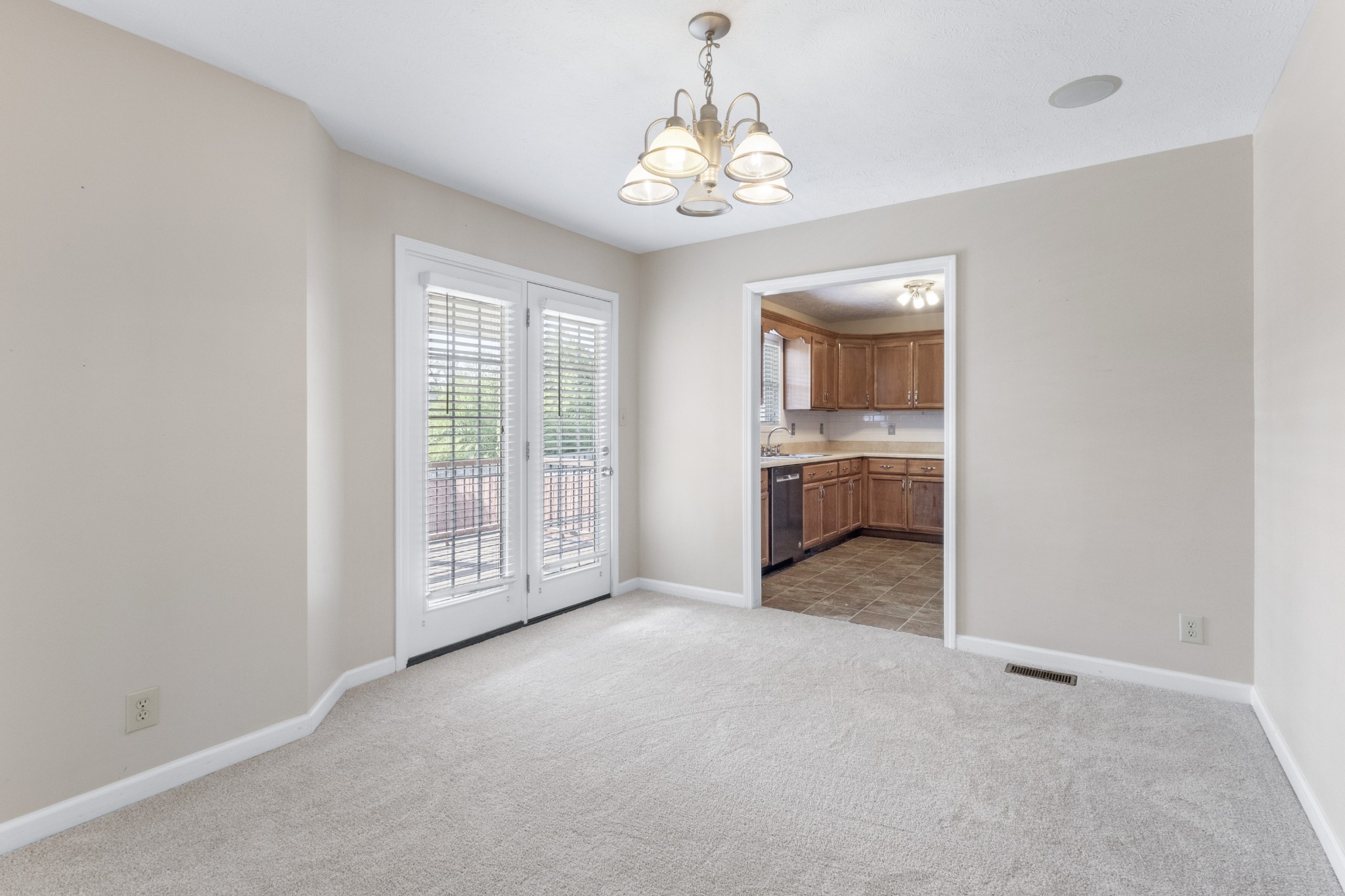 620 Wolfchase Drive Clarksville, TN 37042 - Photo 10 of 24 an empty room with chandelier mirror and balcony