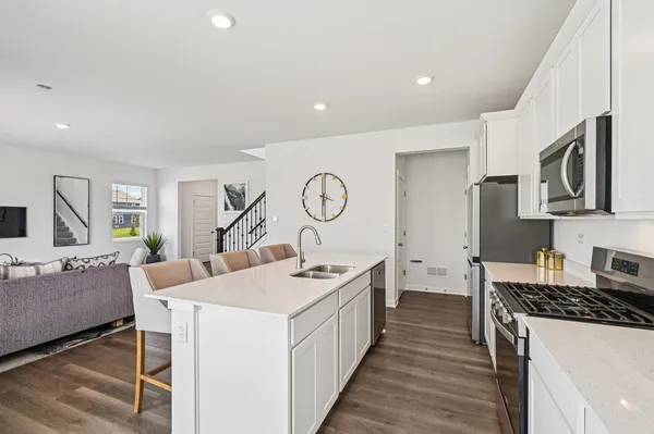 a kitchen with a sink stove and cabinets