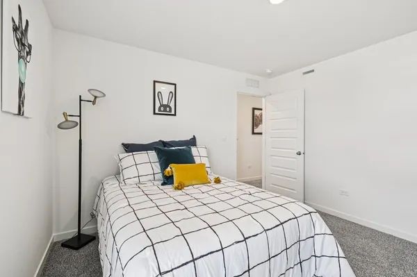 a bedroom with a bed and lamp