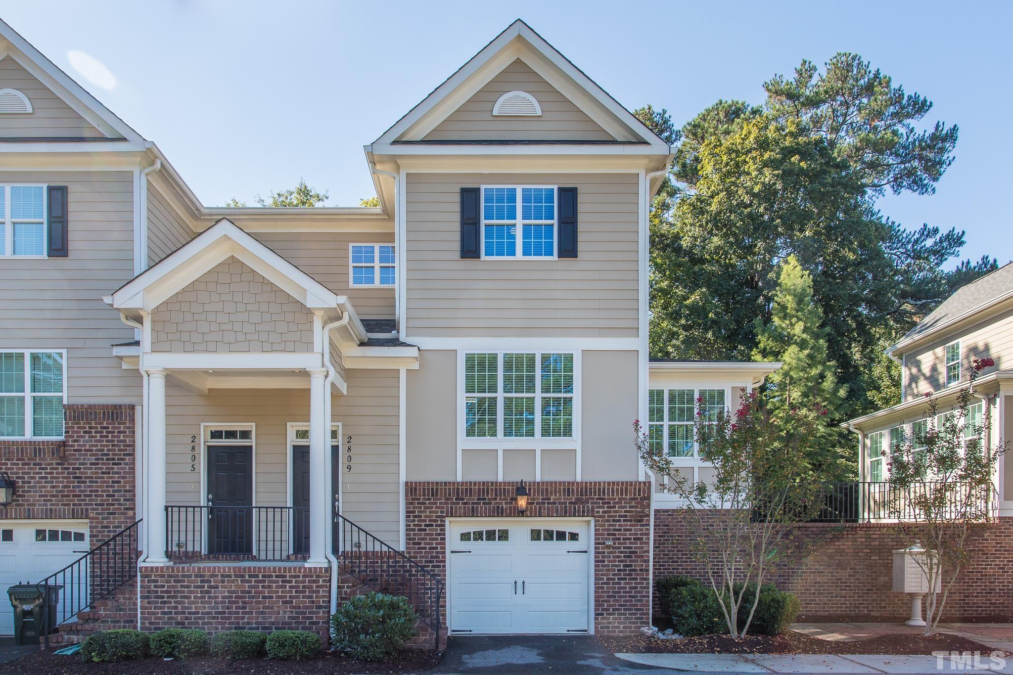 2809 Plumfield Place Raleigh, NC 27607 - Photo 1 of 25 a front view of a house with a yard and garage