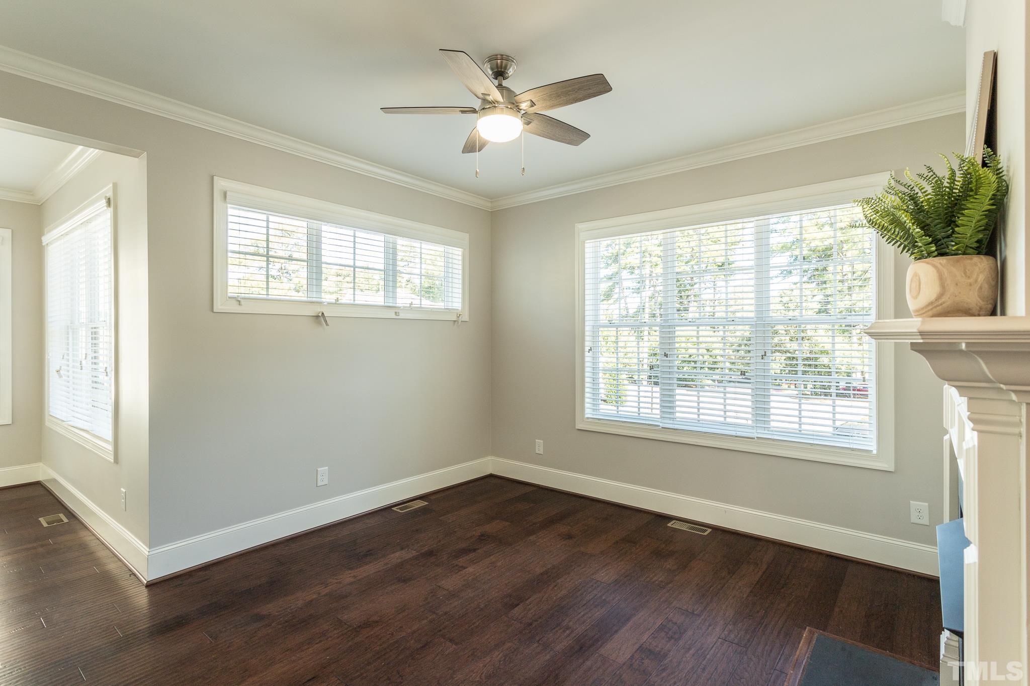 2809 Plumfield Place Raleigh, NC 27607 - Photo 11 of 25 a view of an empty room with wooden floor and a window