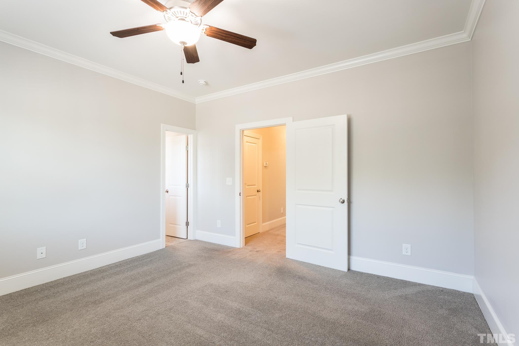 2809 Plumfield Place Raleigh, NC 27607 - Photo 14 of 25 an empty room with closet and a chandelier fan