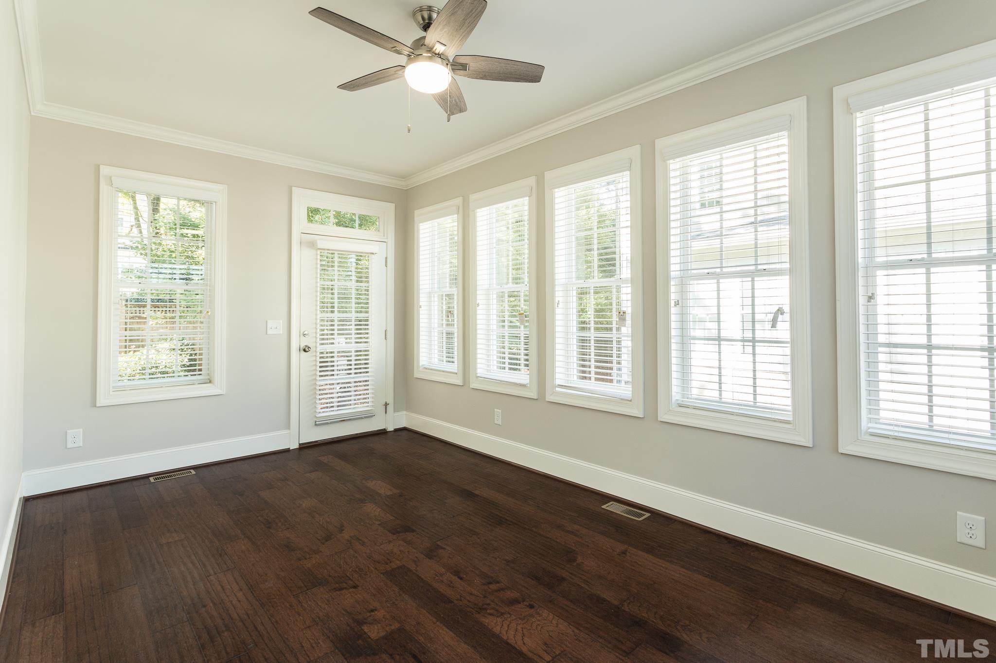 2809 Plumfield Place Raleigh, NC 27607 - Photo 15 of 25 a view of an empty room with wooden floor and a window