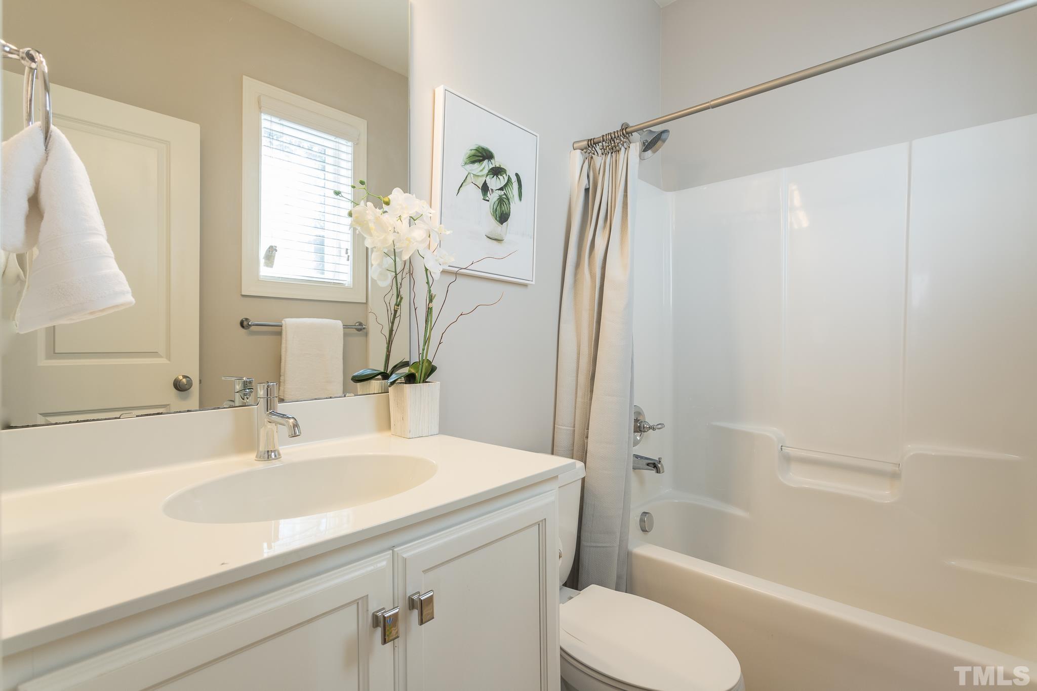2809 Plumfield Place Raleigh, NC 27607 - Photo 6 of 25 a bathroom with a sink toilet and shower