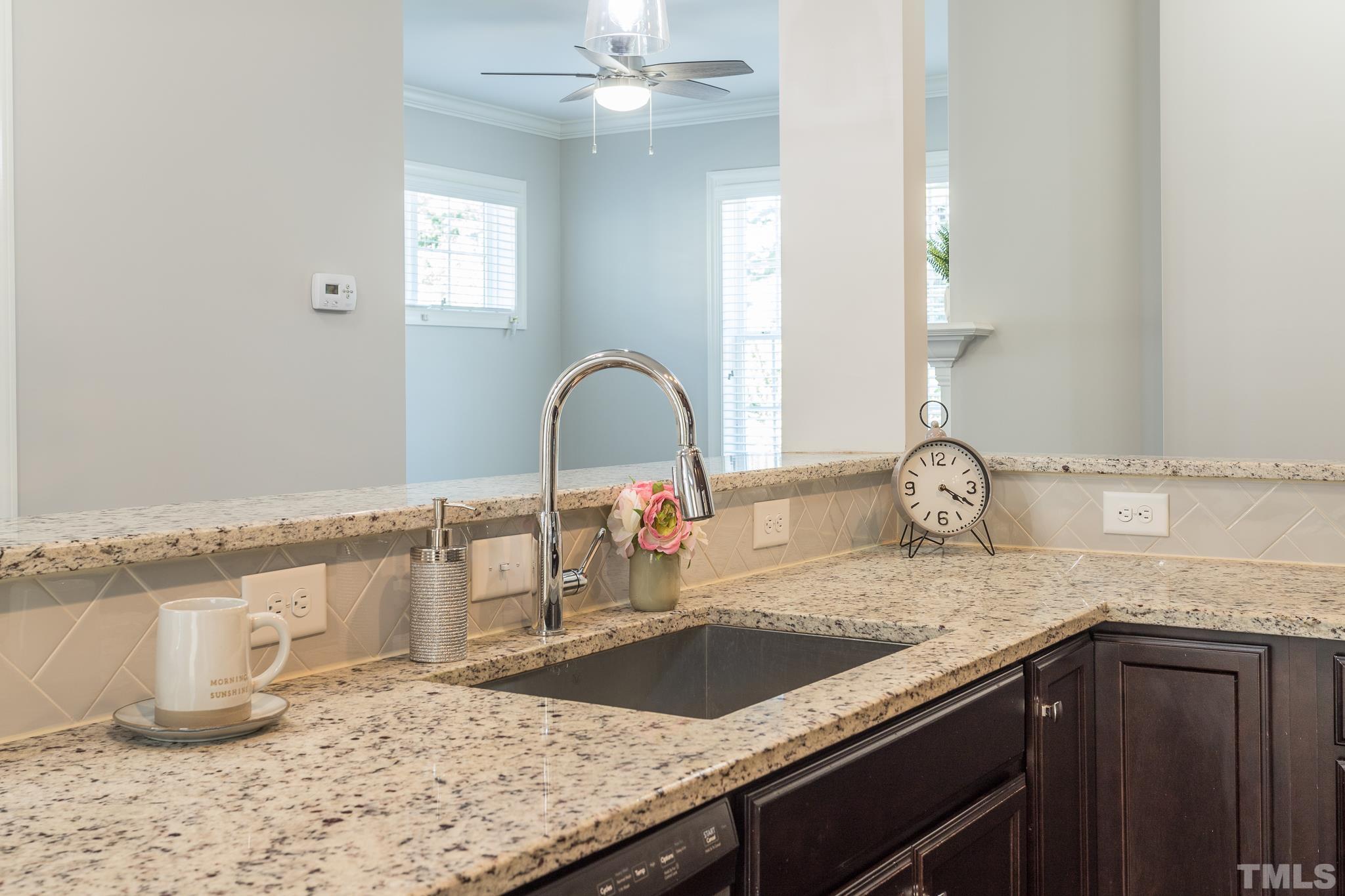 2809 Plumfield Place Raleigh, NC 27607 - Photo 8 of 25 a kitchen with granite countertop a sink and a stove