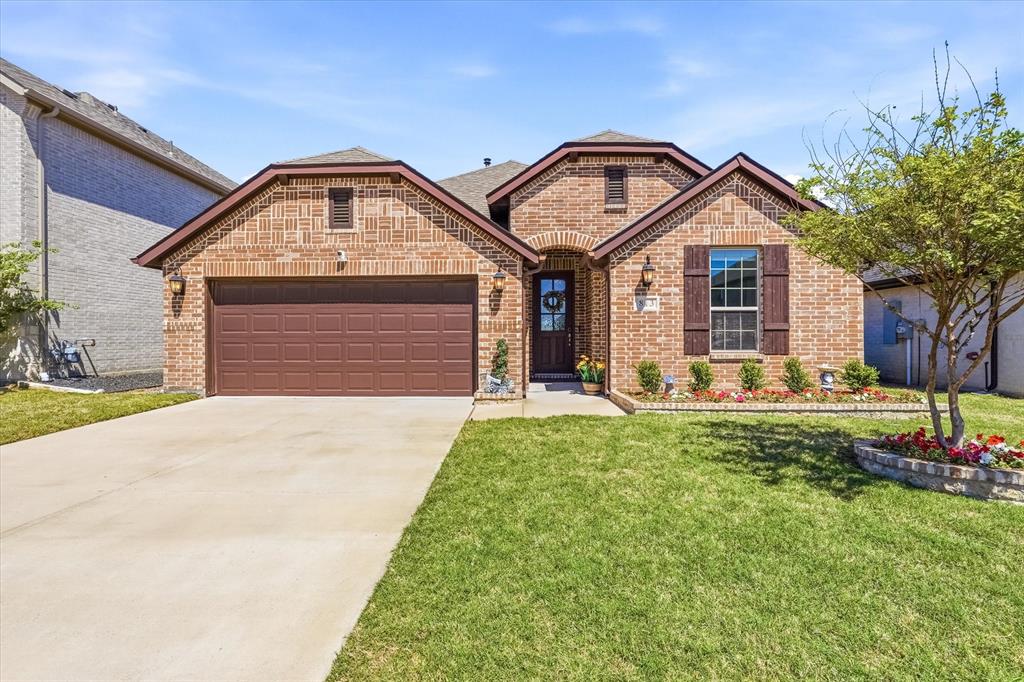 813 Mildren Lane Fate, TX 75087 - Photo 2 of 32 Beautiful drive-up appeal with brick border landscaping and half rain glass front door.