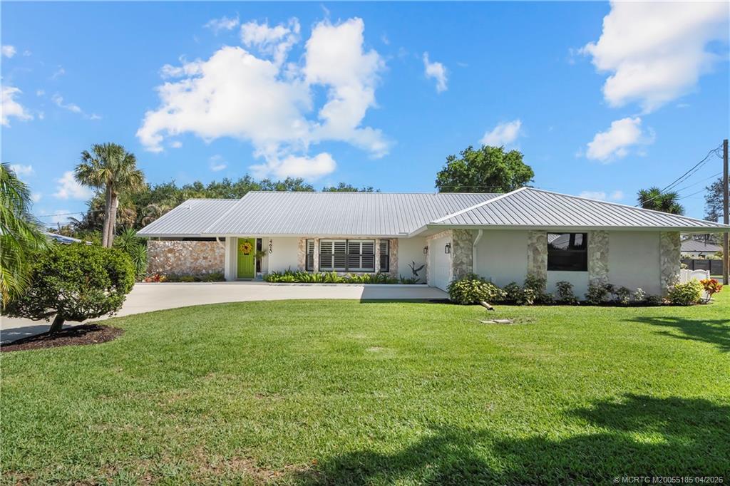 4620 Southeast Quail Trail Stuart, FL 34997 - Photo 39 of 71 a front view of a house with garden