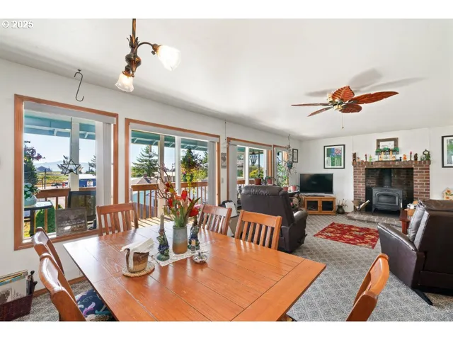 a living room with fireplace furniture and a large window