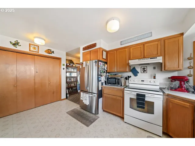 a kitchen with stainless steel appliances a stove a refrigerator and cabinets