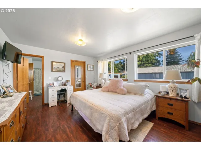 a bedroom with a large bed and a large window