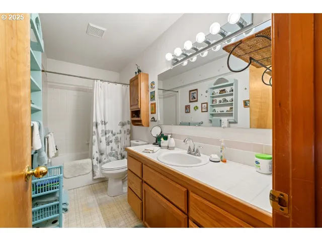 a bathroom with a sink a mirror and a shower