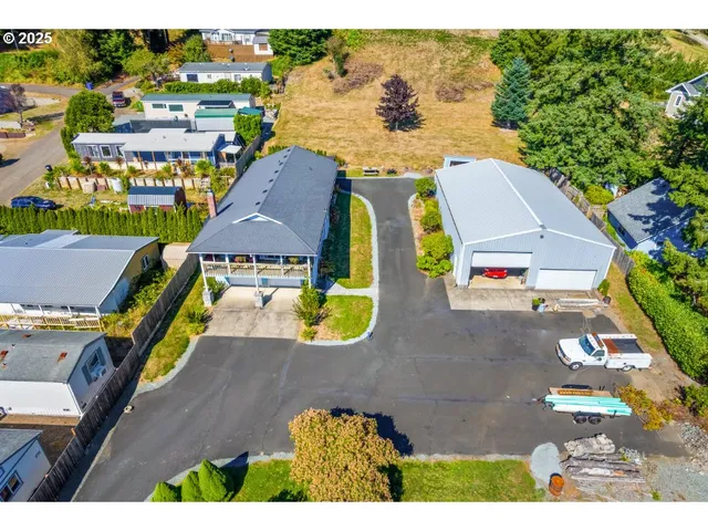an aerial view of residential house with outdoor space and swimming pool
