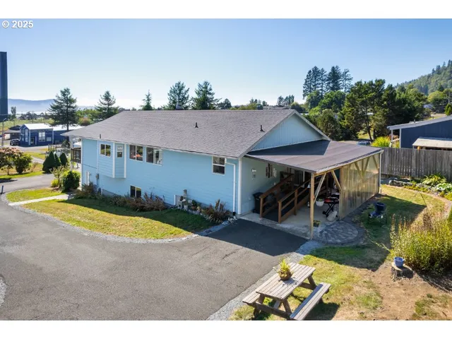 a view of a house with swimming pool and sitting area