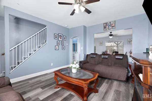a living room with furniture and a chandelier