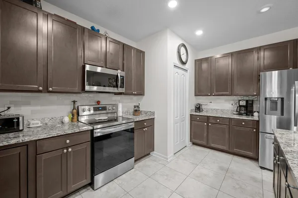 a kitchen with granite countertop stainless steel appliances and cabinets