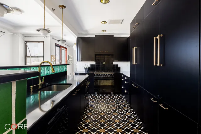 a work room with furniture a large window and wooden floor