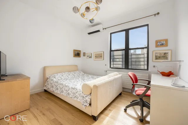 a bedroom with a bed and a television